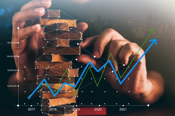 business man try to build wood block on wooden table and black background business organization startup concept