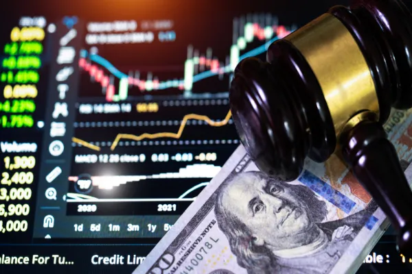 Investment concept,US paper currency on Laptop and gavel,Money with a hammer.