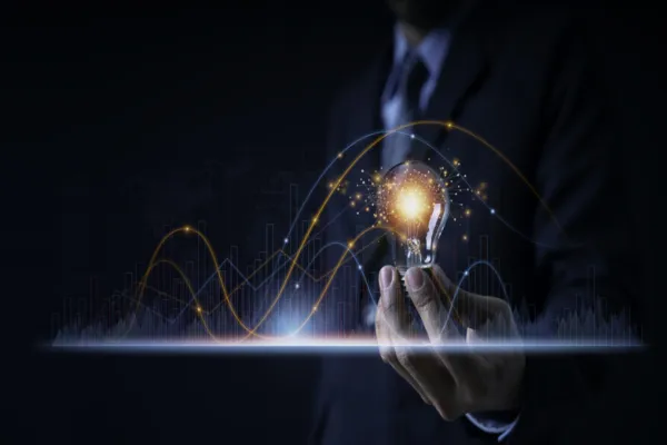 Businessman holding a light bulb showing ideas or investment planning, marketing strategy, has realistic graphs showing business growth