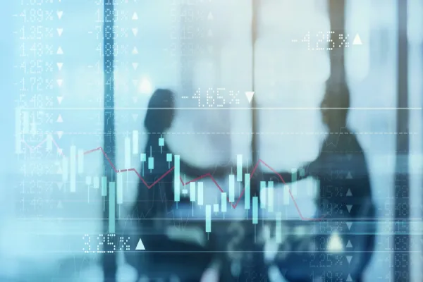 Digitally enhanced shot of a two businesspeople shaking hands in the boardroom superimposed over a graph showing the ups and downs of the stock market