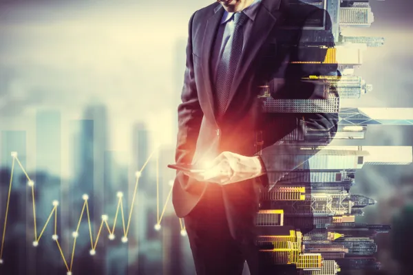 Businessman holding smart phone. Double exposure photo of city view background, Finance strategy concept.