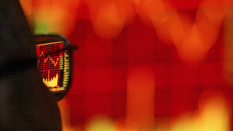 A Chinese customer walks pass the stock index at the end of the trading day in a stock trade floor  in Shanghai, China on 26 April, 2004. 