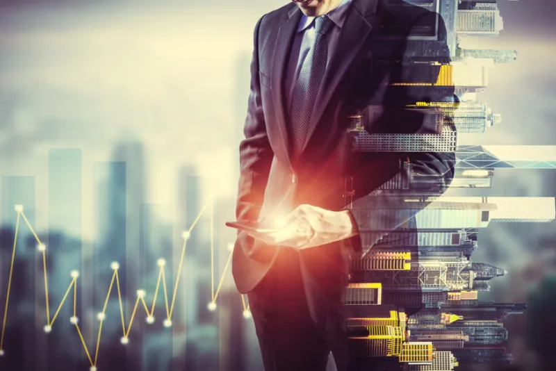 Businessman holding smart phone. Double exposure photo of city view background, Finance strategy concept.