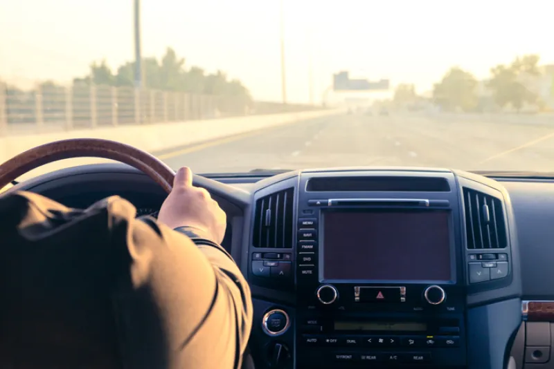 Inside the car, driving on the highway at sunset in Dubai UAE.
