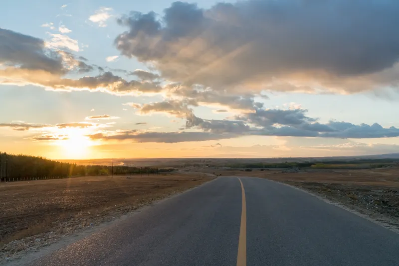 an empty road in the sunset